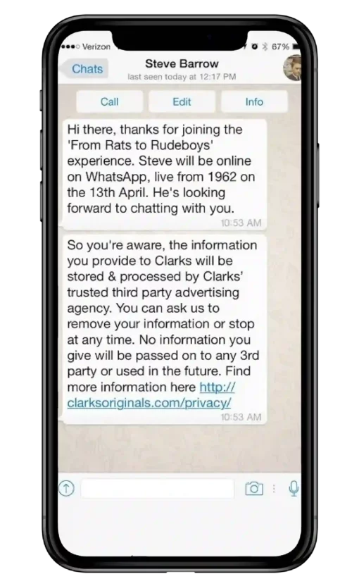 A mobile phone displaying a WhatsApp message from Clarks sharing information about the brand’s history